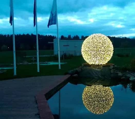 Havuz kenarında örgü dokulu sıcak beyaz LED küre, su yansımalı gece çekimi