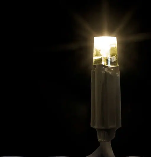 Siyah fonda koyu gövdeli, ışınlar saçan sıcak beyaz tek LED lamba